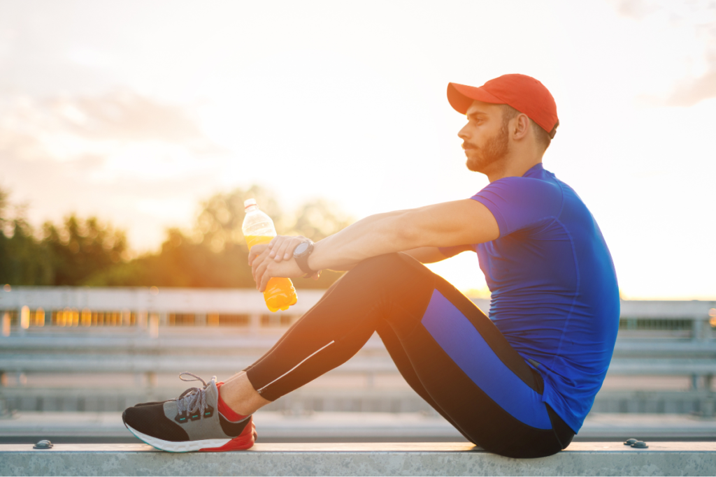 An athlete sat on a track contemplating mental strength