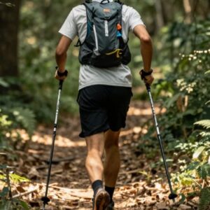 A man running along a trail with walking poles